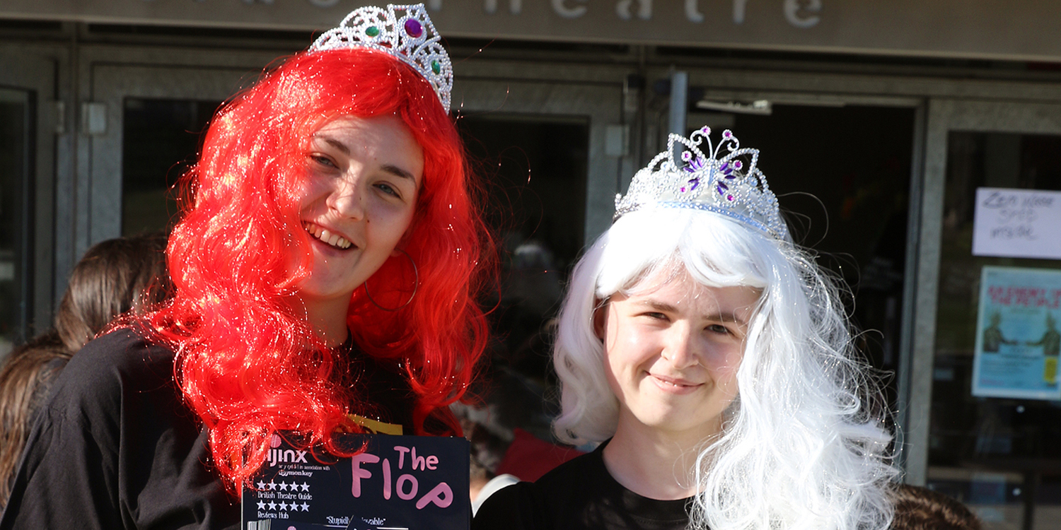 Students in wigs flyering the show