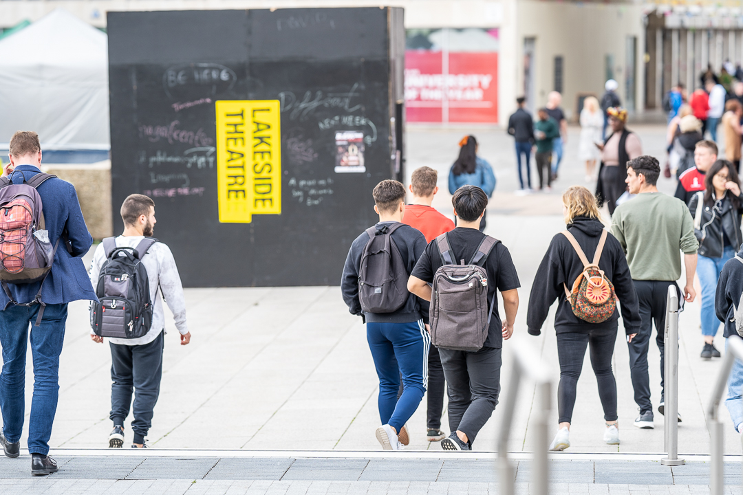 students walking on campus with a black box that says Lakeside Theatre