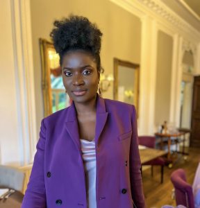 University of Essex law graduate and the visionary behind Steelacts Productions., Ophelia Charlesworth looks incredible in a purple suit jacket with her black kinky hair tied in a top knot.