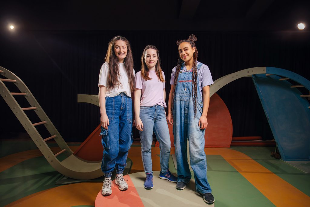 The cast of Protest, three young teenage girls, stand in defiance on the set of Protest the stage play, written by Hannah Lavery.