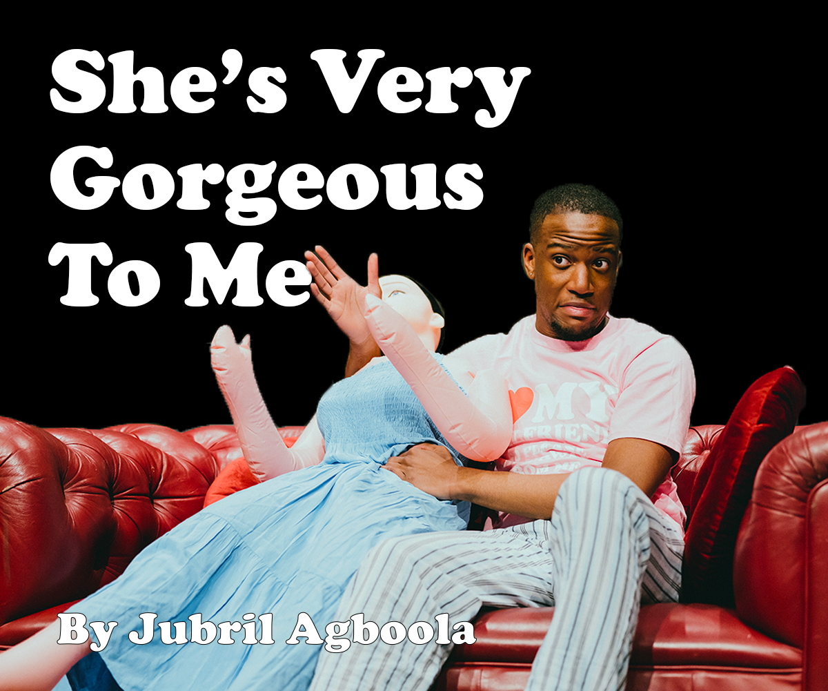 "She's Very Gorgeous To Me, by Jubril Agboola", a young black ma sits on a red sofa with a sex doll dressed in a blue dress.